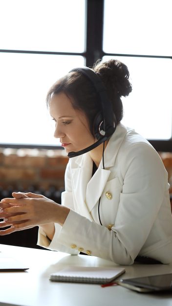 Woman working in call center as dispatcher