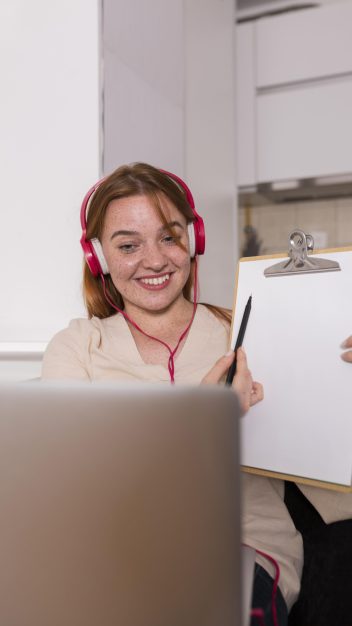 female-teacher-showing-students-online-class-lesson-notepad